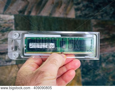 Paris, France- Feb 4, 2021: Pov Male Hand Holding New Computer Ram Random Acces Memory In Plastic Ca