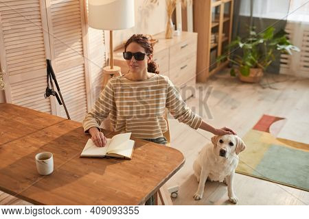 Warm Toned Portrait Of Modern Blind Woman Reading Braille Book While Sitting At Table In Cozy Home I