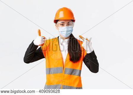 Covid-19 Safety Protocol At Enterpise, Construction And Preventing Virus Concept. Asian Female Chief