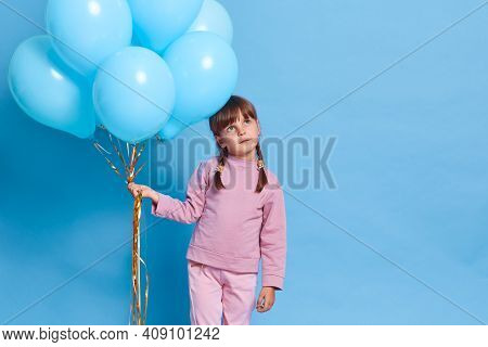 Cute European Female Child Wearing Rose Closing, Kid With Pigtails Looking Way With Thoughtful Facia