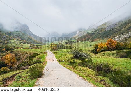 Road In A Valley In Somiedo National Park In Asturias, Spain On A Rainy Autumn Day. Scenic Autumnal 