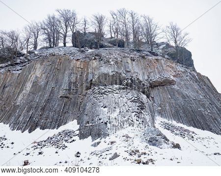 Zlaty Vrch, Rock Formation Of Pentagonal And Hexagonal Basalt Columns. Covered By Snow And Ice In Wi