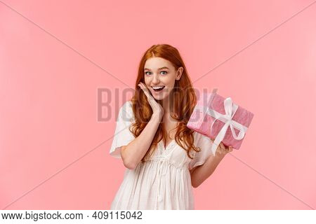 Surprised, Silly And Lovely Feminine Redhead Girl Receive Gift, Look Amused And Wondered, Didnt Expe