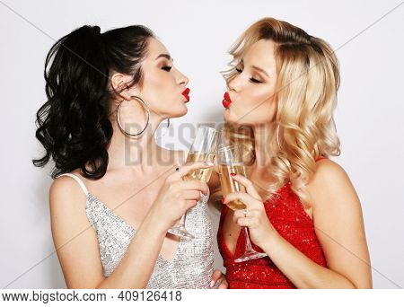 Couple of Two Young Rich Women - blonde and brunette Laughing with Crystal of Champagne. Luxury and celebrate concept. Party time.