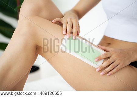 Woman Uses Wax Tape To Remove Hair On Legs
