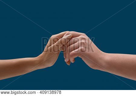 Close Up Of Two Female Hands Holding Each Other To Symbolize Taking Care Of Each Other Isolated Over