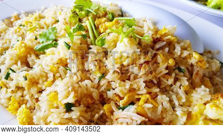 Close Up Crab Meat Fried Rice With Egg And Sliced Coriander Topping On White Dish Or Plate. Asian Fo
