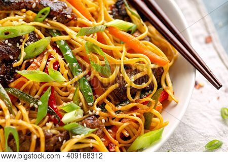 Stir Fry Noodles With Beef And Vegetable In White Bowl. Asian Style Food