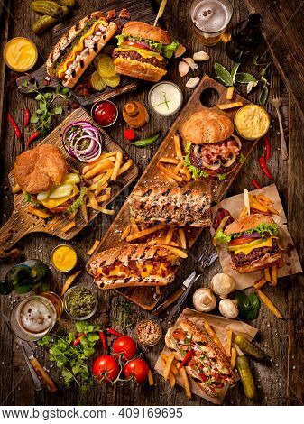 Elicious Burger With Sauce. Hamburger. Delicious Grilled Angus Burger With Cheese, Salad And Tomatoe