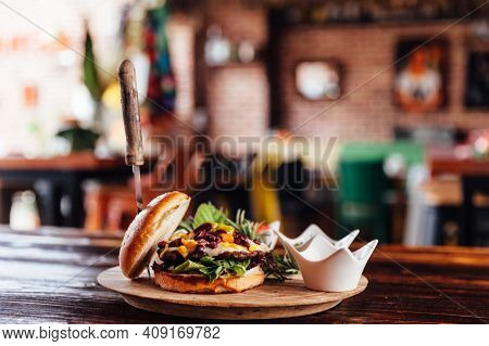 Elicious Burger With Sauce. Hamburger. Delicious Grilled Angus Burger With Cheese, Salad And Tomatoe