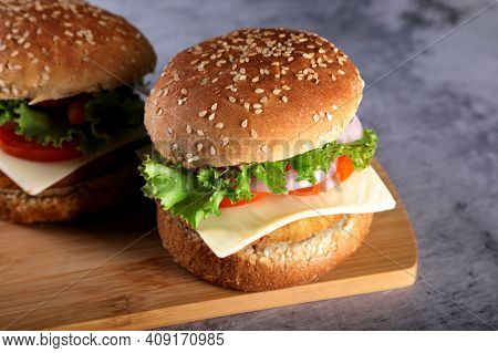 Elicious Burger With Sauce. Hamburger. Delicious Grilled Angus Burger With Cheese, Salad And Tomatoe