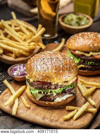Elicious Burger With Sauce. Hamburger. Delicious Grilled Angus Burger With Cheese, Salad And Tomatoe
