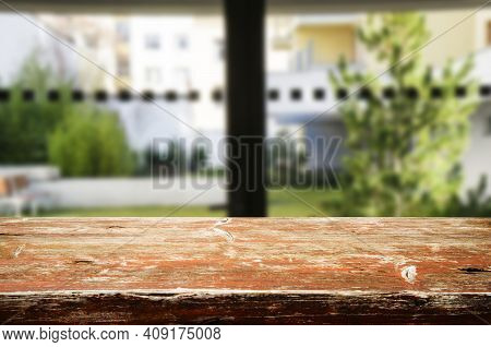 Wooden Brown Table Top Against The Blurred Corridor, Passage And Courtyard Of The House .for Product