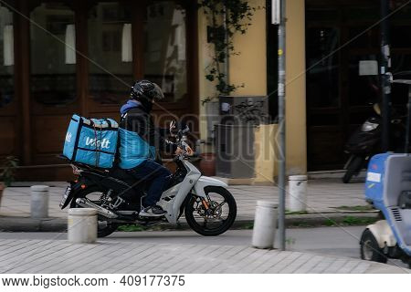 Thessaloniki, Greece - February 20 2021: Wolt Food Courier On Motorbike Speeding On City Road. Day V