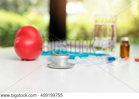 Stethoscope, Syringe And Medical Equiupments With Vaccine On Table. Healthcare And Medicine Concept.
