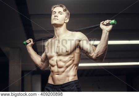 Fitness Man At Workout In Gym With Bodybar Stretching Muscles. Workout Fitness And Bodybuilding Heal