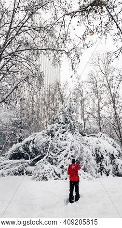 Madrid - January 9, 2021: A Lonely Woman Takes A Picture With Her Smartphone In A Park In Madrid Dur