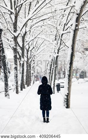 Madrid - January 9, 2021: A Lonely Woman Takes A Picture With Her Smartphone In A Park In Madrid Dur