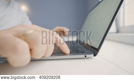 Close-up Of Man Typing On Laptop Keyboard. Action. Printing Letter Or Dissertation On Laptop. Man In