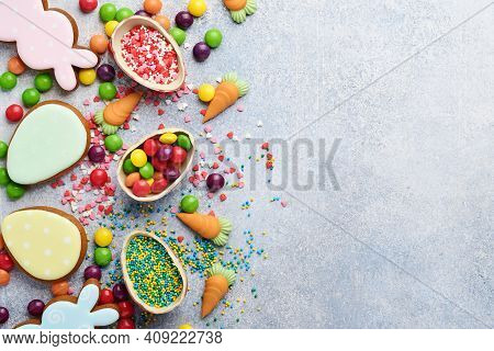 Chocolate Easter Eggs And Colorful Sweets On Gtay Background Greeting Card. Top View. Flat Lay With 