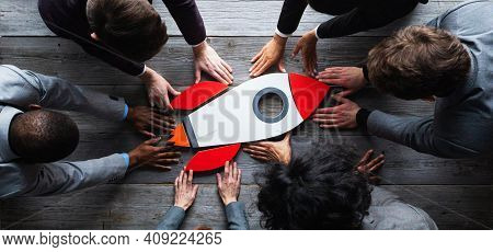 Team Of Business People With Rocket As A Sumbol Of High Risky Goals Targets Success At Meeting Table