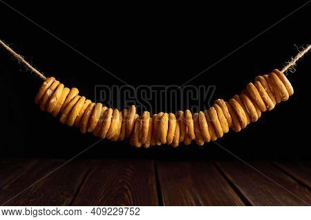 Traditional Russian Bagels On A Rope On Black Background