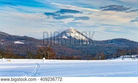 Winter Hilly Landscape Of Lusatian Mountains With Klic Mountain In The Middle. Czech Republic