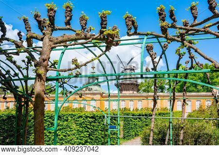 New Chambers (neue Kammern) Palace And Windmill (windmuhle) In  Sanssouci Park In Spring, Potsdam, G