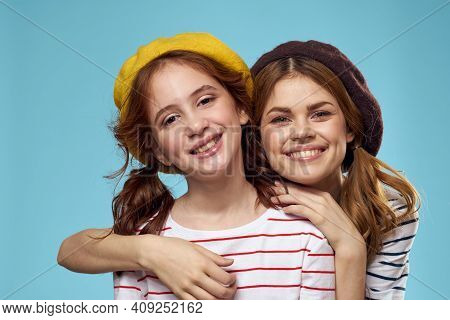 Fashion Sisters In Hats Fun Lifestyle Blue Background Studio