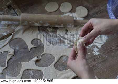 Process Of Making Vareniki, Rolled Dough, Rollong Pin And Flout At Kitchen Table, Cooking Concept.