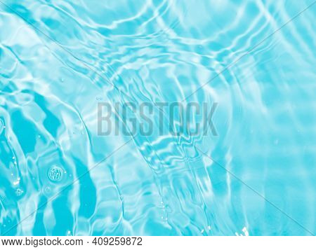 Blurred Ripple Water Texture On Blue Pool Background. Shadow Of Water On Sunlight. Mockup For Produc