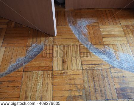 Scratched Parquet Flooring In The Room. Scratches, Chips And Dents On The Floor. Parquet In Need Of 
