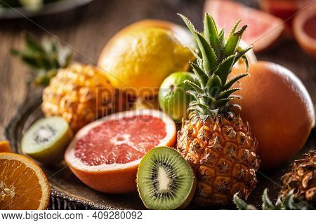 Assortment Of Fresh Exotic Fruit Ideal For Detox On A Rustic Wood Surface.