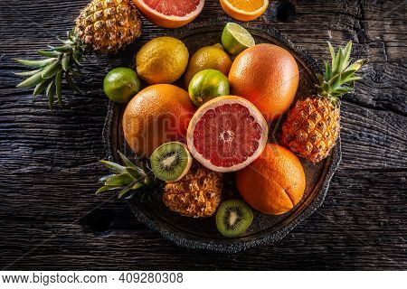 Top View Of Exotic Fruit And Citruses On A Vintage Wood.