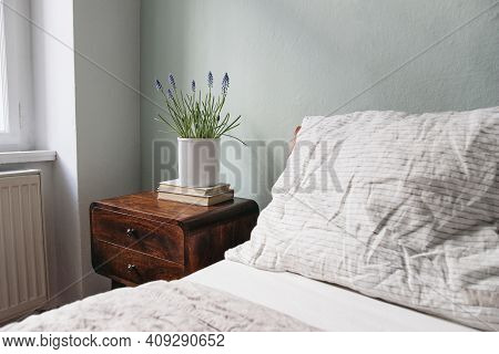 Bedroom Closeup View. Striped White And Beige Linen Pillows And Blanket. Wooden Bed And Night Stand.