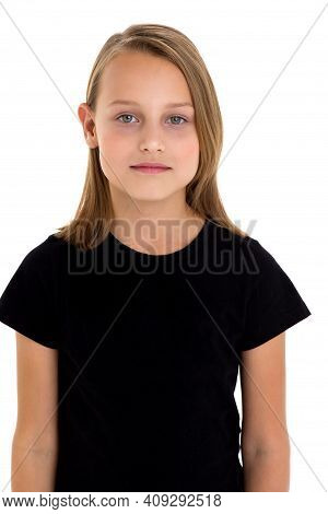 Pretty Blonde In A Black T-shirt. Girl In Fashionable Clothes Posing In The Studio. Close Up Portrai