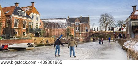 Winsum, Netherlands - February 14, 2021: Panorama Of People Skating On The Winsumerdiep River In Win