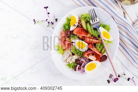 Ketogenic Diet Breakfast. Salt Salmon And Baked Dorado Salad With Greens, Tomatoes, Eggs And Avocado