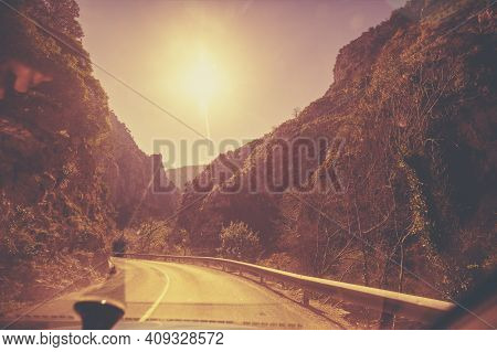 View Of Beautiful Mountain Landscape Through The Windscreen On A Sunny Day. Driving A Car On Mountai