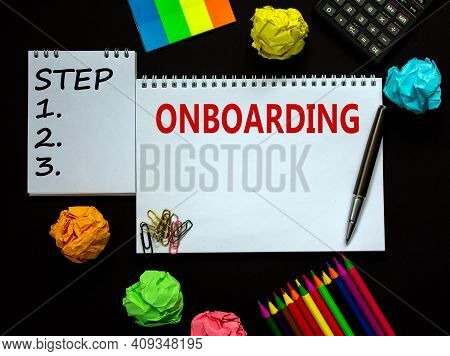 Onboarding Symbol. White Note With A Word 'onboarding' On Beautiful Black Background, Colored Paper,