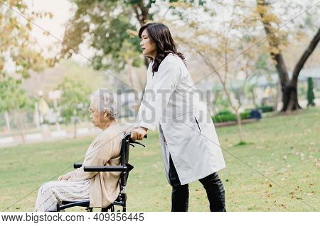 Doctor Help And Care Asian Senior Or Elderly Old Lady Woman Patient Sitting On Wheelchair At Park In