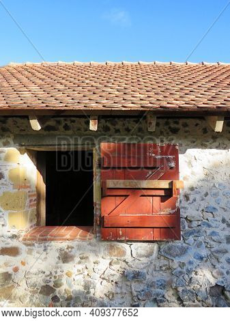 Detail Of Red Shutter And Open Window In Colonial Stone Building With Roof Under Caribbean Blue Sky.