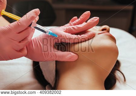 The Doctor Gives An Injection Into The Woman's Cheekbone. Cosmetology Close-up