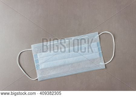 Blue Disposable Medical Mask On A Gray Background
