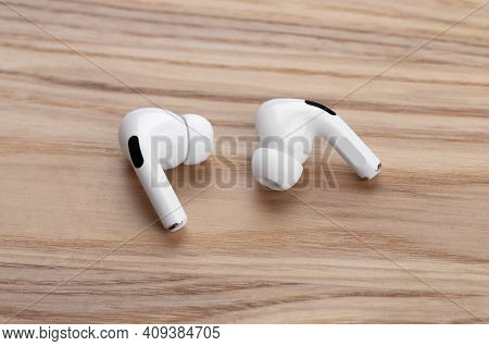 Rostov-on-don, Russia - December 2019. Apple Airpods Pro On A Wooden Table. Wireless Headphones Clos