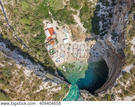 Aerial Overhead Drone Shot Of Tourists Swim Sunbath At Stiniva Beach On Vis Island In Croatia Summer
