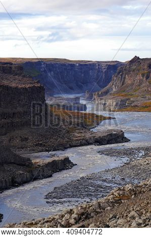 A Canyon With A Mountain In The Background