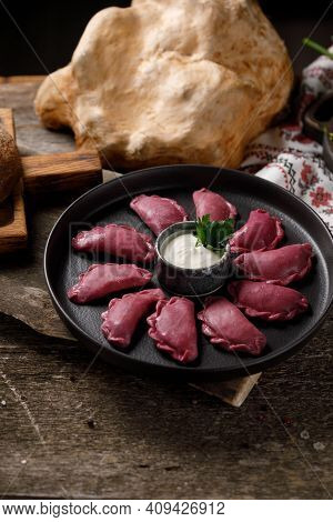 Delicious Traditional Russian Dumplings, Handmade Dough Painted With Beets. Still Life On A Wooden B