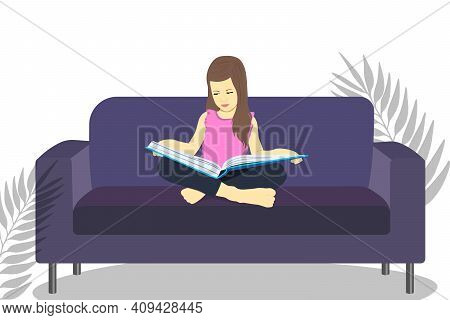 Little Girl Reads A Book And Sits On A Sofa. Distance Learning. Home Education. School Girl Girl Doi