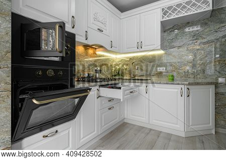 Modern classic luxury white kitchen interior, electric and microwave ovens doors are open